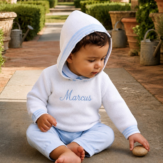 Carriage Boutique personalized white cotton hooded baby sweater with blue trim and embroidered name on chest