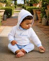 Carriage Boutique personalized white cotton hooded baby sweater with blue trim and embroidered name on chest