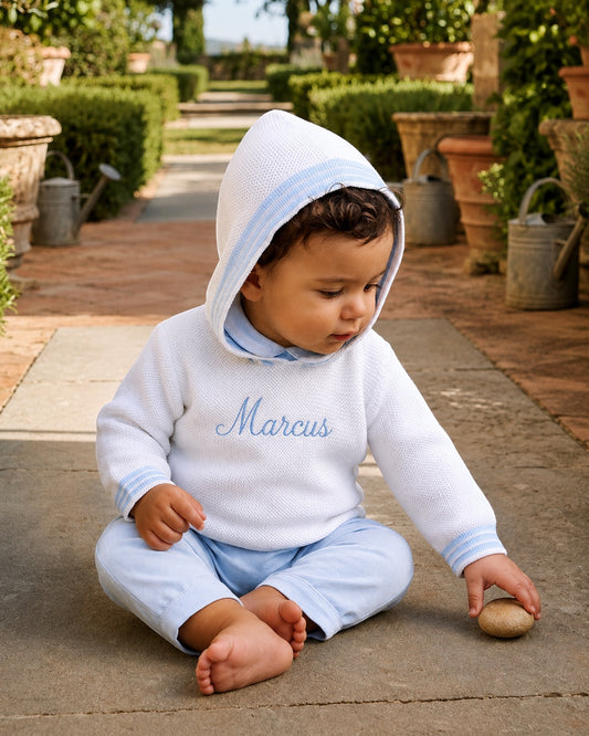 Carriage Boutique personalized white cotton hooded baby sweater with blue trim and embroidered name on chest