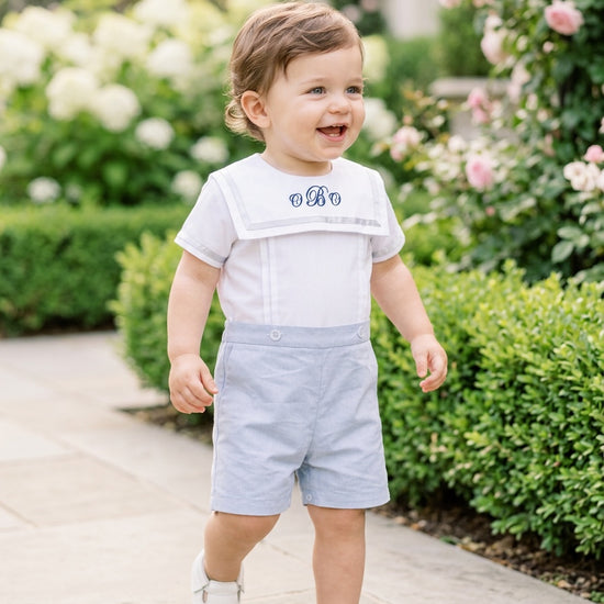 Carriage Boutique toddler wearing a personalized gray bobby suit with monogrammed white shirt and matching shorts