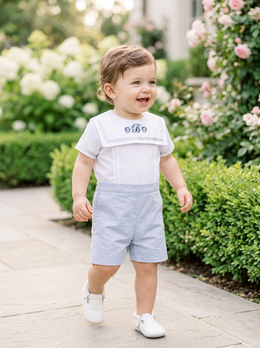 Carriage Boutique toddler wearing a personalized gray bobby suit with monogrammed white shirt and matching shorts