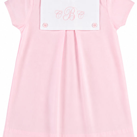 Carriage Boutique personalized baby girl dress in light pink cotton with a white button bib and monogram embroidery.