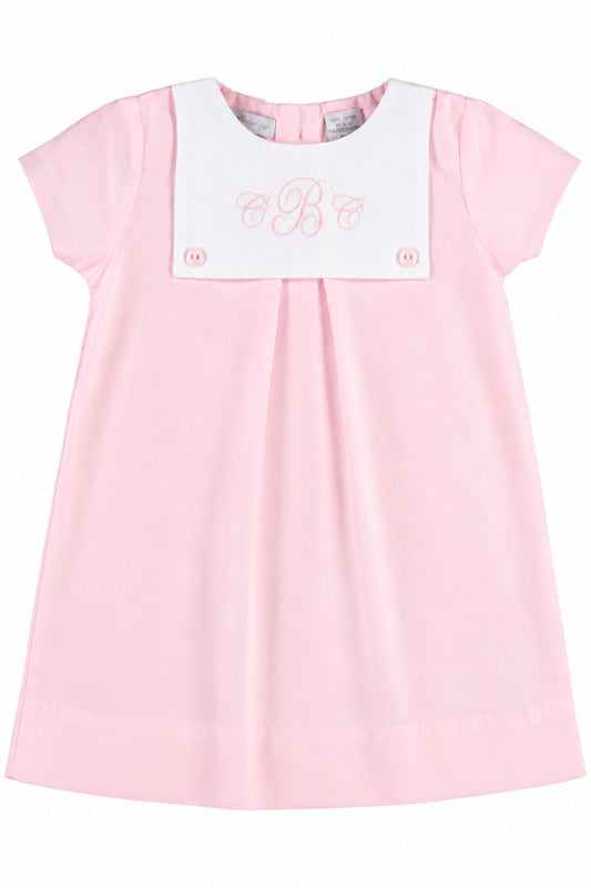 Carriage Boutique personalized baby girl dress in light pink cotton with a white button bib and monogram embroidery.