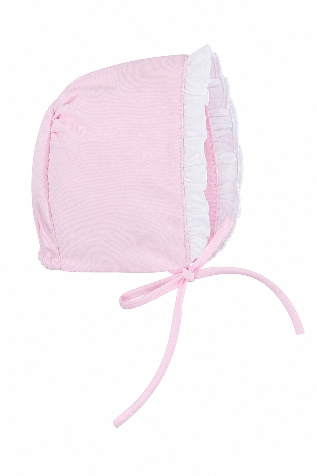 Carriage Boutique baby girl bonnet in soft pink fabric with white ruffled trim and tie closure for Easter.