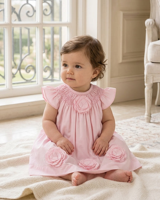 Carriage Boutique baby girl dress in classic pink with smocked bodice and delicate cut-out flower appliqués