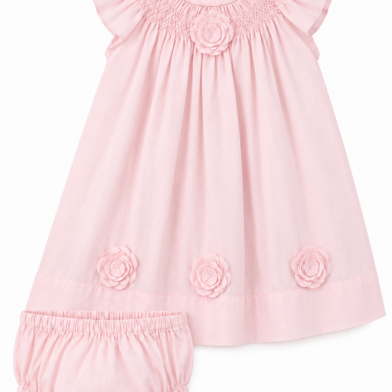 Carriage Boutique classic pink baby girl dress with flutter sleeves, smocked bodice, and floral cut-out details.