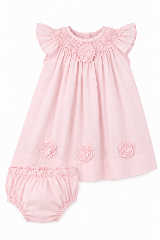 Carriage Boutique classic pink baby girl dress with flutter sleeves, smocked bodice, and floral cut-out details.