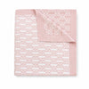 Carriage Boutique soft pink and white cotton baby blanket with a classic knit monogram pattern