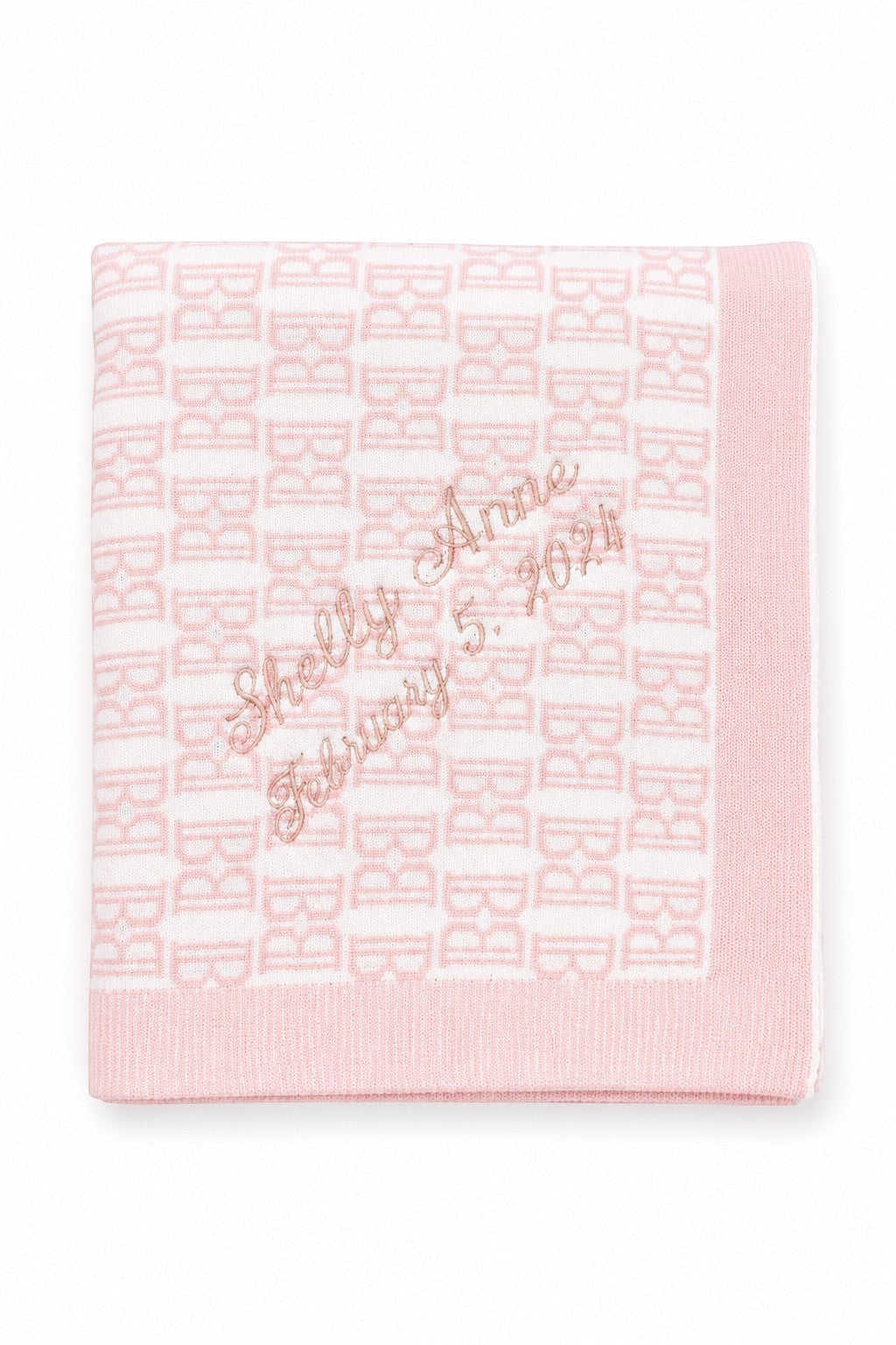 Carriage Boutique pink and white cotton baby blanket with custom embroidered name and date in a soft knit pattern.