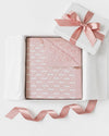 Carriage Boutique pink and white cotton baby blanket with monogram pattern in a gift box with a satin ribbon.
