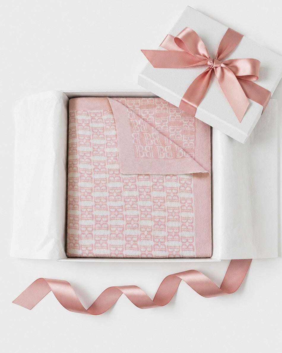Carriage Boutique pink and white cotton baby blanket with monogram pattern in a gift box with a satin ribbon.