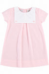 Carriage Boutique personalized baby girl dress in light pink cotton with a white button bib and short sleeves.