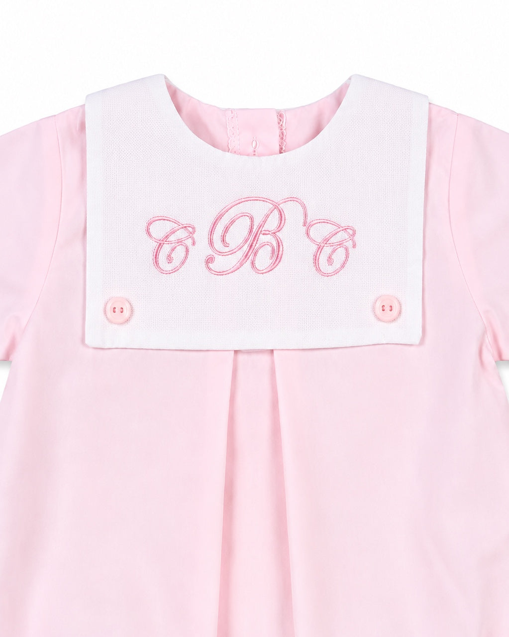 Carriage Boutique baby girl bubble romper in light pink cotton with a white button bib and pink monogram embroidery