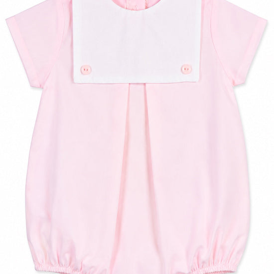 Carriage Boutique baby girl bubble romper in light pink cotton with a white button bib and short sleeves.