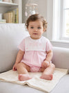 Carriage Boutique baby girl bubble romper in light pink cotton with a white button bib and custom pink embroidery.