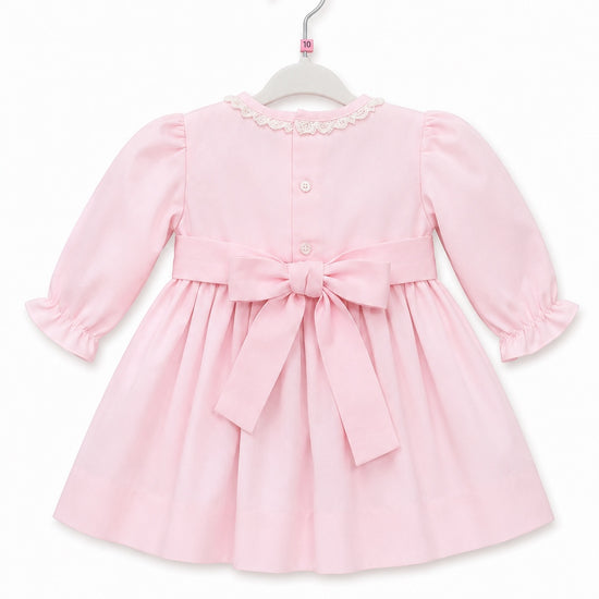 Carriage Boutique light pink cotton baby dress with long puffy sleeves, lace collar, and back bow sash
