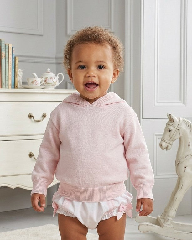 Carriage Boutique baby girl wearing a soft pastel pink cotton knit hooded sweater with ribbed trim.