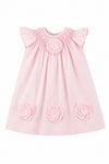 Carriage Boutique baby girl dress in classic pink featuring delicate cut-out flower appliqués and smocked neckline.