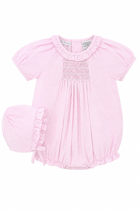Carriage Boutique pink gingham cotton baby girl bubble romper with hand-embroidered smocking and matching bonnet hat.