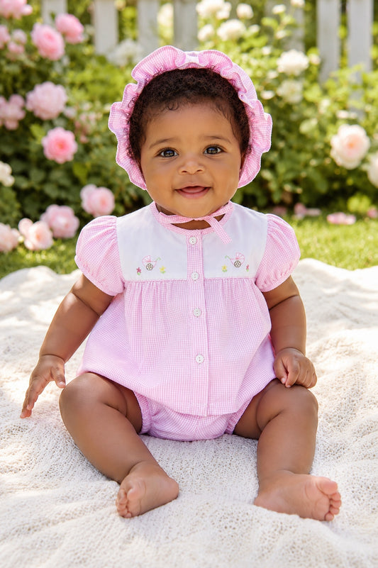 Carriage Boutique baby girl pink gingham bubble romper with hand-embroidered carriage design and matching ruffled hat.