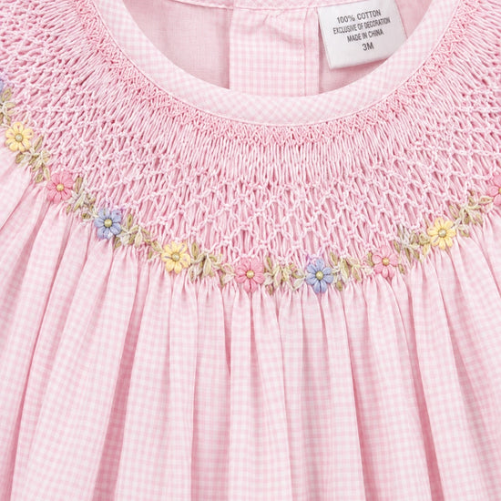 Carriage Boutique pink gingham baby girl bishop dress with hand-embroidered floral smocking and flutter sleeves