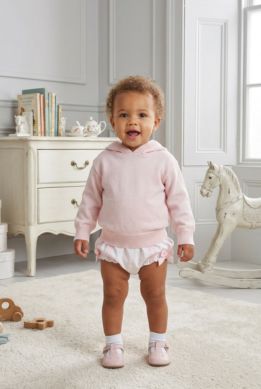 Carriage Boutique baby girl wearing a soft pastel pink cotton knit hooded sweater with white ruffled bloomers