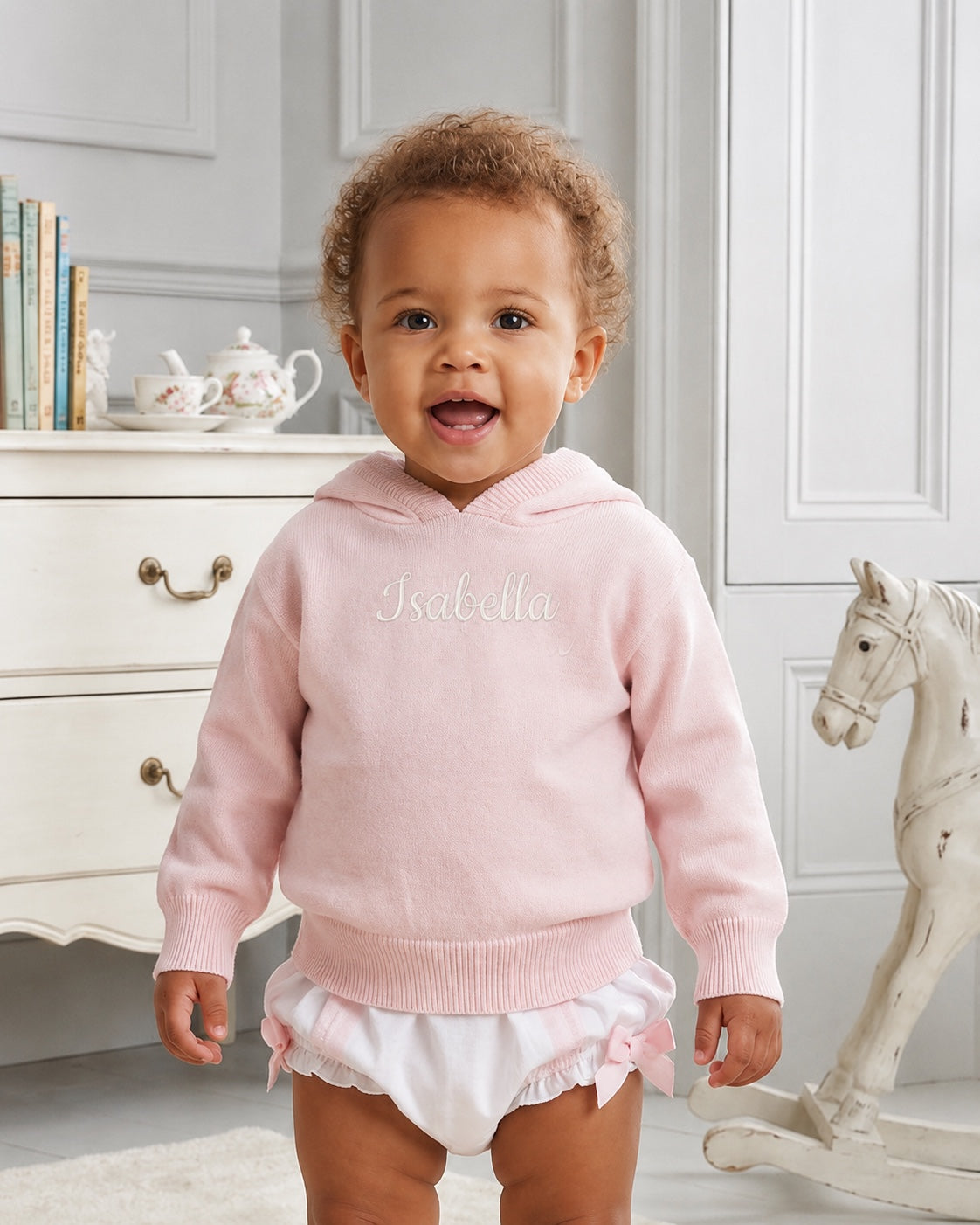 Carriage Boutique baby girl wearing a soft pink cotton knit hooded sweater with personalized embroidery
