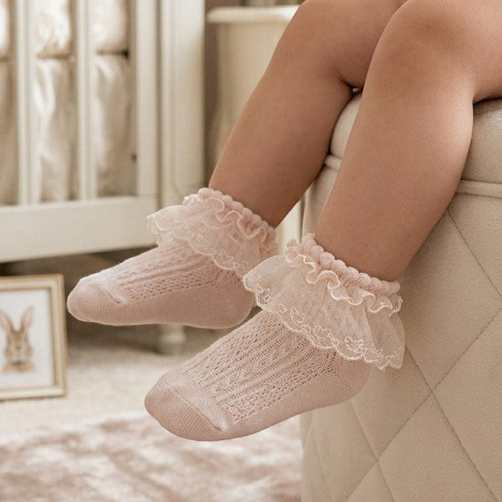 Carriage Boutique baby girl christening socks in soft pink with delicate angel wing lace trim and ribbed detailing.