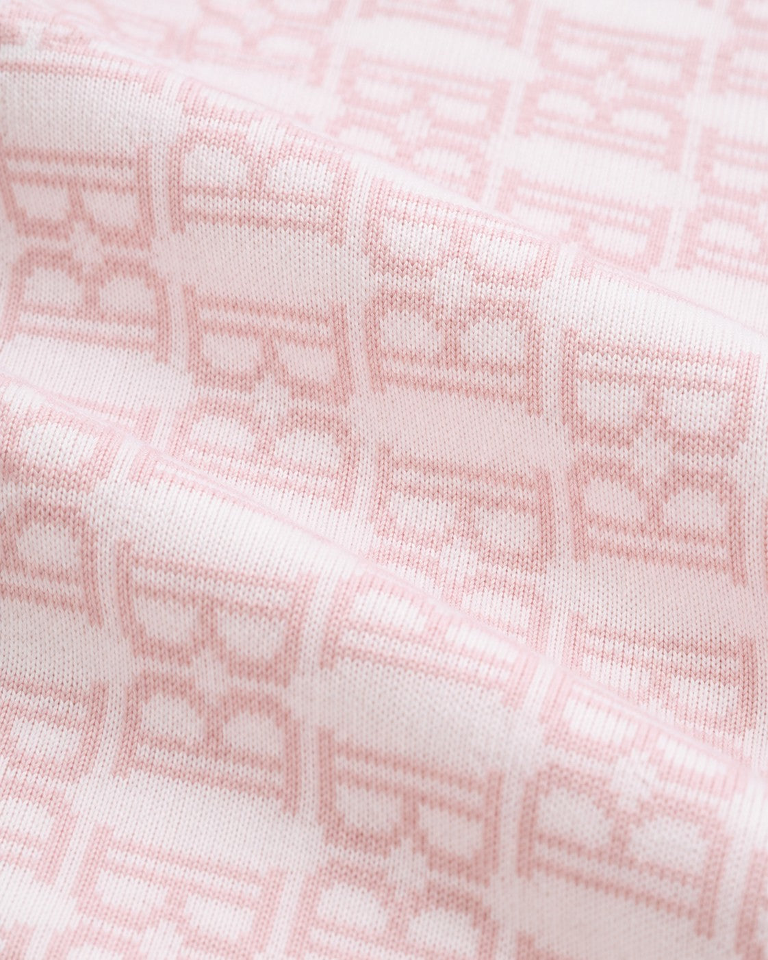 Carriage Boutique soft pink cotton baby blanket with a classic knit monogram B pattern for a cozy nursery.