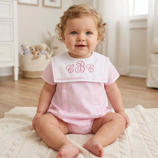 Carriage Boutique baby girl bubble romper in pink with white Peter Pan collar and custom monogram embroidery.
