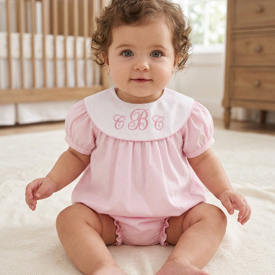 Carriage Boutique pink cotton bubble romper with white Peter Pan collar and custom monogram on a baby girl