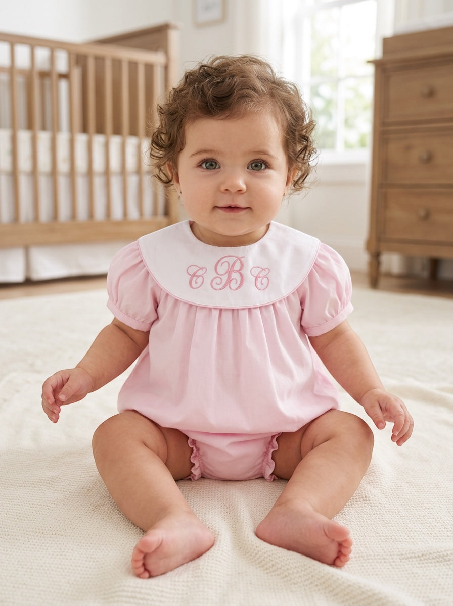 Carriage Boutique pink cotton bubble romper with white Peter Pan collar and custom monogram on a baby girl