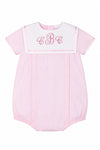 Carriage Boutique pink pinstripe baby bubble romper with a white Peter Pan collar and custom monogram embroidery.