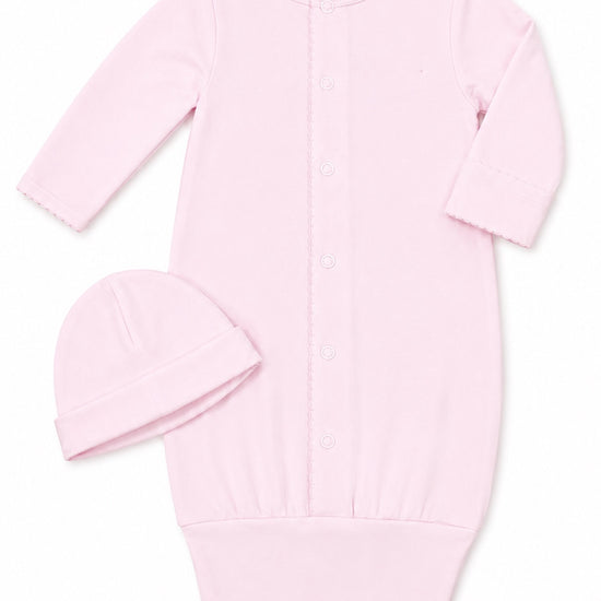 Carriage Boutique pink newborn sleep sack with matching hat, long sleeves, and scalloped trim on a white background.