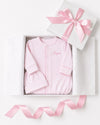 Carriage Boutique pink newborn sleep sack and matching hat with personalized name embroidery in a gift box.
