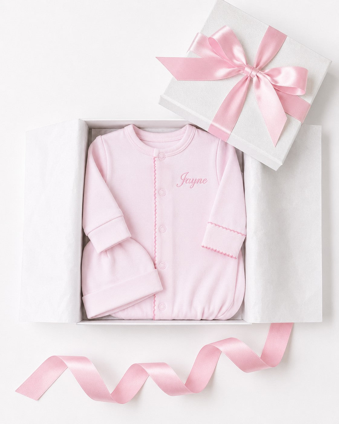 Carriage Boutique pink newborn sleep sack and matching hat with personalized name embroidery in a gift box.