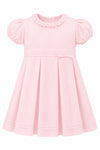 Carriage Boutique baby and toddler girl dress in soft pink pique fabric with a ruffled collar and pleated skirt.