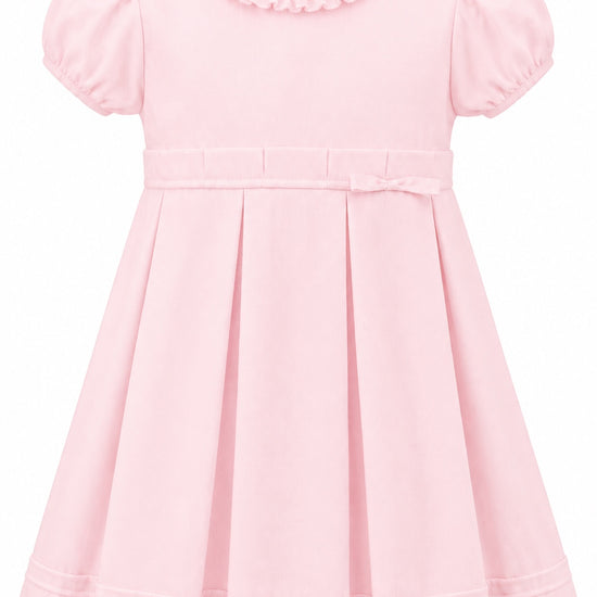 Carriage Boutique pink pique toddler girl dress with a ruffled collar, puff sleeves, and a pleated skirt.