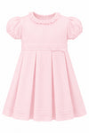 Carriage Boutique pink pique toddler girl dress with a ruffled collar, puff sleeves, and a pleated skirt.