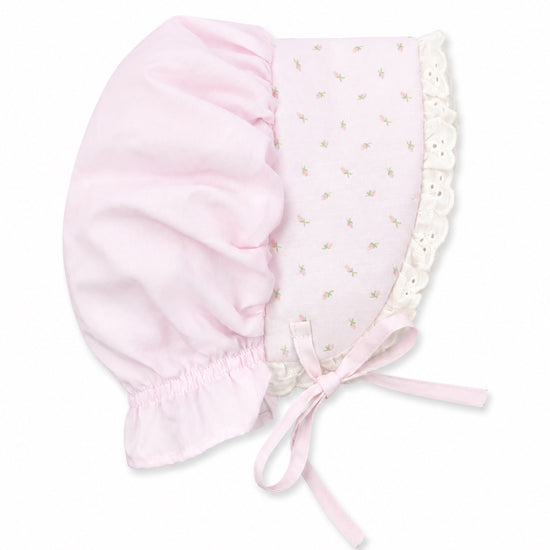 Carriage Boutique baby bonnet in pink with rosebud print, featuring delicate lace trim and ribbon tie closure.