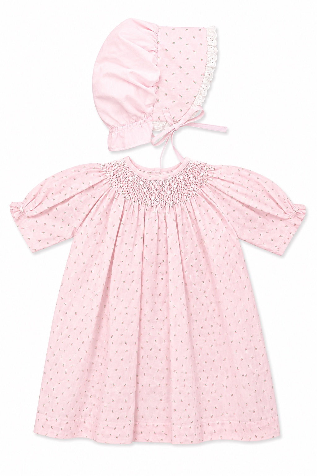 Carriage Boutique pink cotton baby dress with rosebud print, smocked bodice, and matching lace-trimmed bonnet.