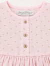 Carriage Boutique baby girl dress in soft pink with a delicate rosebud print, featuring wooden buttons and a round neck