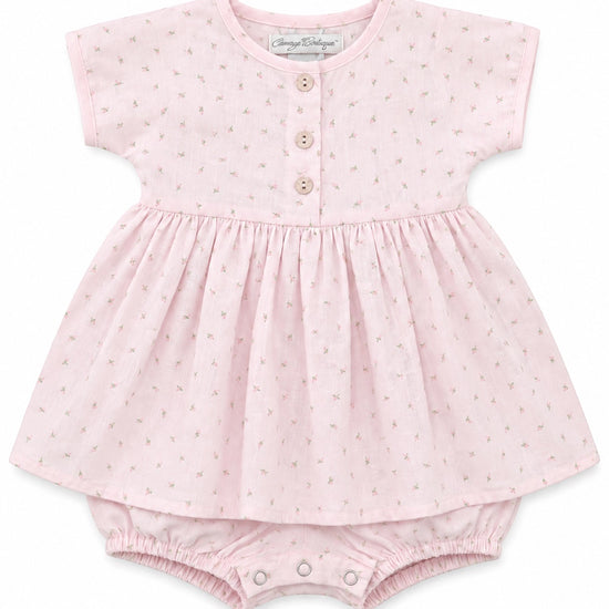 Carriage Boutique baby girl dress in soft pink with a delicate rosebud print, wooden buttons, and matching bloomers.