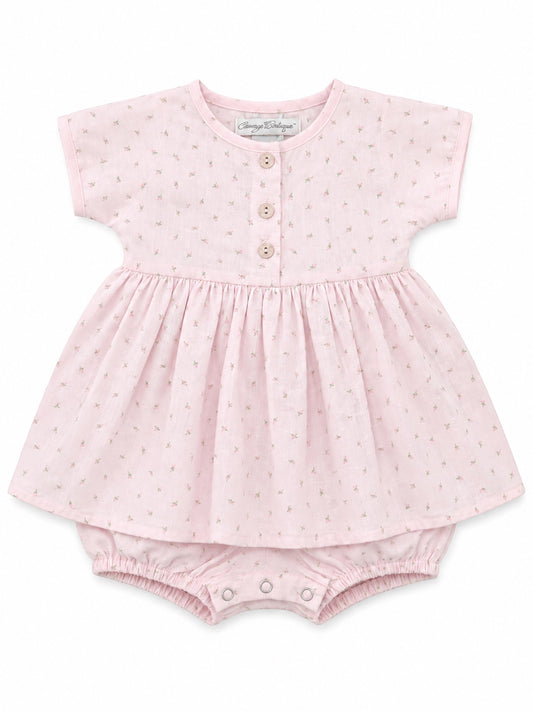 Carriage Boutique baby girl dress in soft pink with a delicate rosebud print, wooden buttons, and matching bloomers.