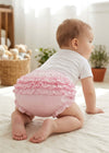 Carriage Boutique baby girl wearing pink ruffled diaper cover bloomers with an elastic waistband while crawling.