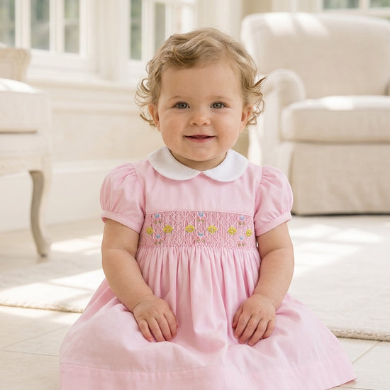 Carriage Boutique baby girl pink pique dress with hand-smocked floral waist and white peter pan collar