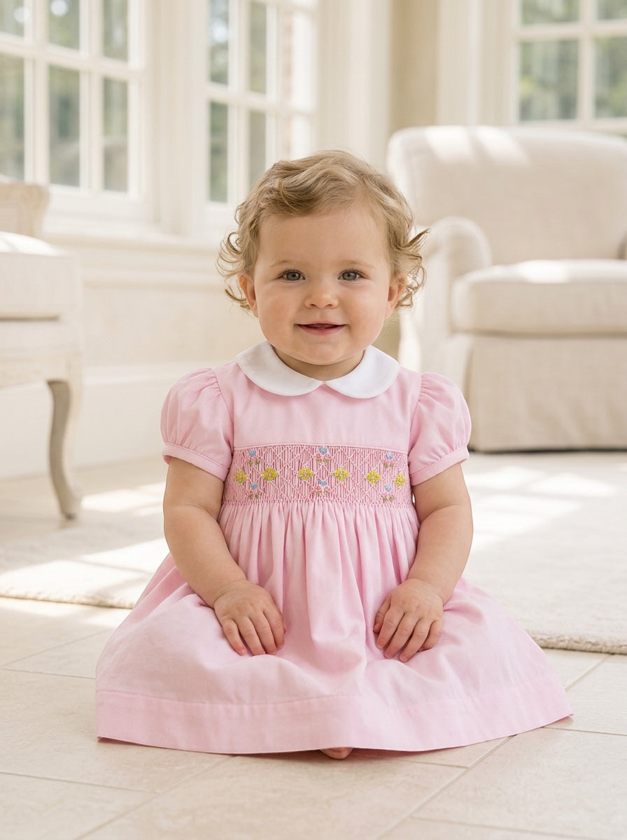 Carriage Boutique baby girl pink pique dress with hand-smocked floral waist and white peter pan collar