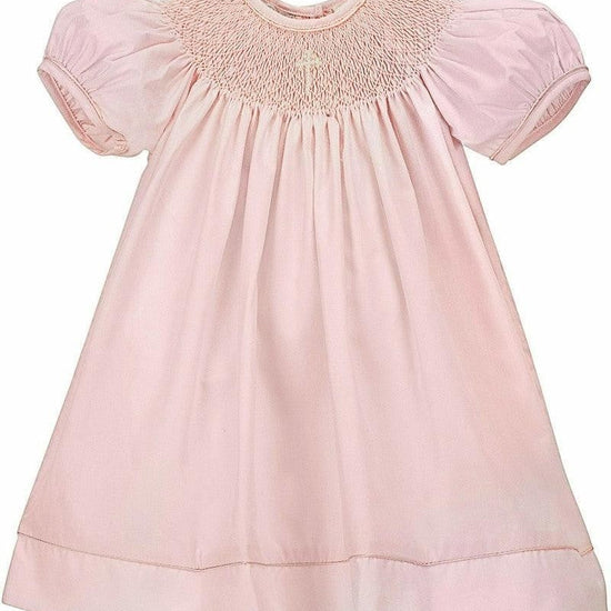 Carriage Boutique pink hand-smocked bishop dress with pearl cross detail and puff sleeves, includes matching bonnet.