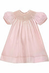 Carriage Boutique pink hand-smocked bishop dress with pearl cross detail and puff sleeves, includes matching bonnet.