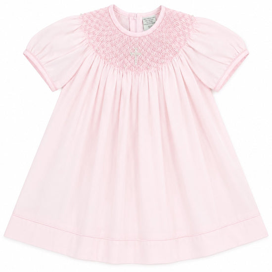 Carriage Boutique baby girl pink cotton bishop dress with hand-smocked pearl cross detail and matching bonnet.